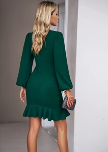 Detail of elegant dark green fitted dress with lantern sleeves and ruffle hem finish
