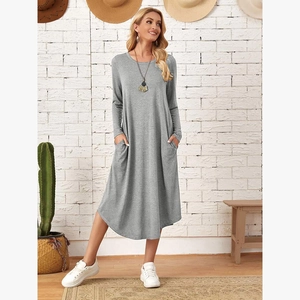 Loose grey long sleeve knit dress with curved hem and side pockets for casual style