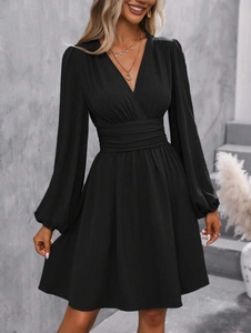 Detail of V-neck long sleeve dress featuring pleated waist and lantern elastic cuffs