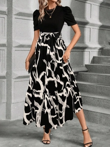 Detail of elegant black bodice and bubble sleeves with tied waist on floral print dress