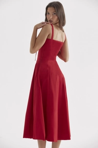 Detail of red midi A-line dress featuring thin spaghetti straps and premium fabric