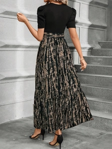 Back view of elegant two-piece set featuring black puff sleeves and printed long skirt