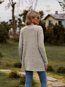 Detail of light gray ribbed knit cardigan showing the long-sleeved texture and vertical pattern