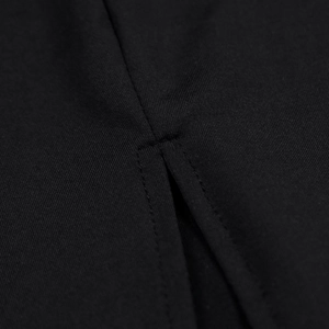 Detailed close-up of a high-quality slit design and bar-tack stitching on black dress