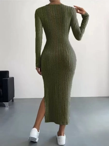 Back view of a long sleeve dark green ribbed knit dress featuring a side slit design