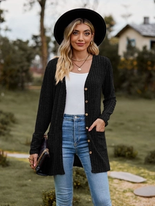 Close-up of black ribbed knit cardigan featuring front pockets and a single-breasted design