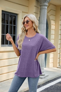 Detail of purple loose-fit crew neck T-shirt with drop shoulders and casual knit texture