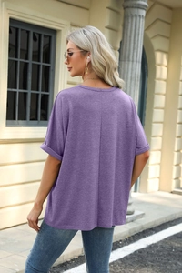 Detail of loose fit dark purple t-shirt showing rolled sleeves and back vertical seam design