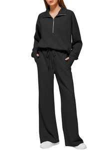 Detail view of black two-piece set featuring half-zip sweatshirt and wide-leg sweatpants
