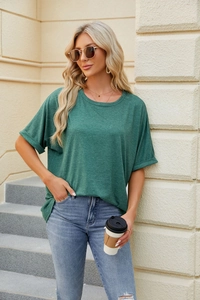 Detail of rolled sleeve cuffs on a loose dark green cotton t-shirt for women