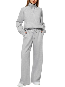 Close-up of grey two-piece set featuring half-zip sweatshirt and wide-leg joggers