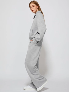Detailed side view of women's gray leisure tracksuit featuring high collar and wide-leg pants