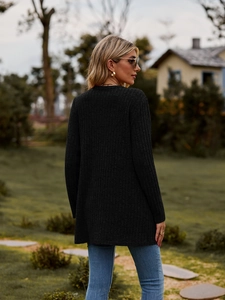 Detail view of women's black ribbed knit cardigan showing the back fit and long sleeve texture