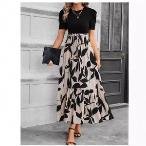 Elegant high-waist maxi dress featuring a black short sleeve top and leaf print skirt