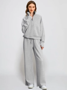 Detailed texture of grey high-neck zip sweatshirt and drawstring wide-leg pants set