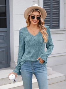 Detail of grey-blue V-neck ribbed knit top featuring lace trim and flared sleeve cuffs