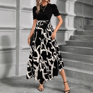 Elegant two-piece style maxi dress with black bodice and patterned skirt for summer