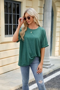 Detailed view of the dark green cotton fabric and rolled cuff sleeves on this women's T-shirt