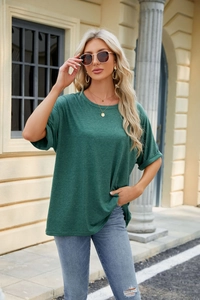 Detail of dark green loose fit cotton t-shirt with rolled sleeves and marled texture