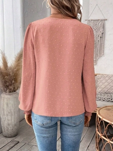 Detail showing Swiss dot textured fabric on the back of a dusty rose long sleeve top
