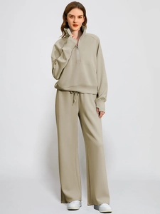 Detail of khaki oversized half-zip sweatshirt and matching wide-leg pants set for women