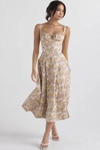 Detail of floral print pattern and drawstring bow on the yellow midi sun dress