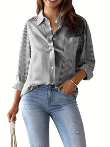 Detail of classic black and white vertical striped shirt with lapel and front pocket