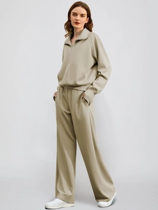 Detail of light khaki zip-up sweatshirt and wide-leg jogger set with clean finish