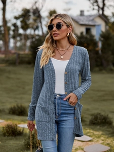 Detail shot of dusty blue ribbed knit texture and side pocket on this casual long cardigan