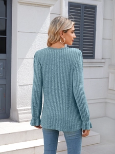 Detail of the sky blue ribbed knit sweater featuring lace neckline and ruffled cuffs