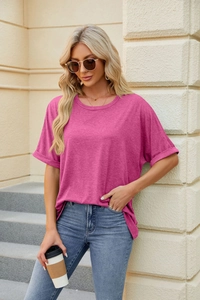 Detail of rose red loose fit t-shirt featuring casual rolled sleeves and round neckline