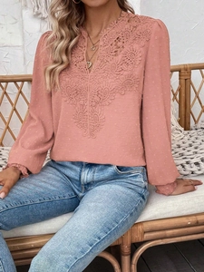 Close-up of pink long sleeve top with delicate lace crochet and Swiss dot textured fabric