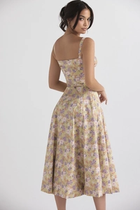 Detail of floral spaghetti strap midi dress showing elegant open back and A-line silhouette