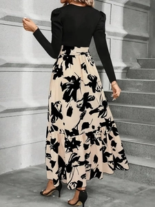 Elegante completo con top nero a maniche a sbuffo e gonna lunga a stampa floreale