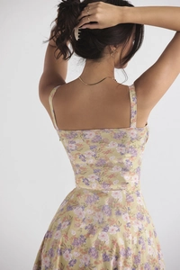Detail of floral printed summer dress showing back square neckline and purple flower patterns