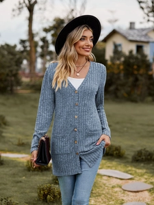 Detail of light blue ribbed knit cardigan featuring front buttons and functional side pockets