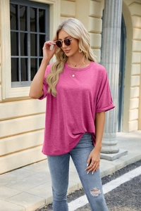 Outdoor lifestyle shot of rose pink loose fit T-shirt with rolled sleeves and round neck