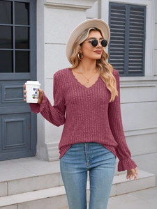 Detail of V-neckline with lace trim and ribbed texture on this long sleeve slim top