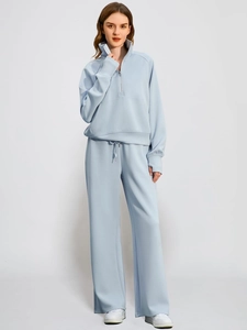 Detail view of light blue women's two-piece set with half-zip hoodie and wide-leg pants