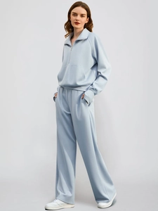 Light blue two-piece lounge set with half-zip sweatshirt and wide-leg jogger pants