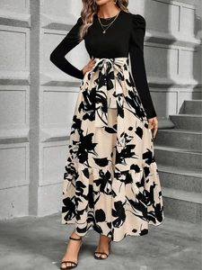 Abito elegante a maniche lunghe con corpetto nero e gonna a fiori con fiocco in vita
