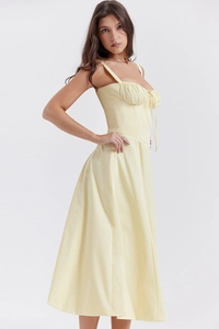 Detail of pale yellow midi dress with corset-style bodice and drawstring ruching