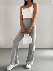 Detailed view of light gray ribbed knit fabric on high-waisted flare trousers