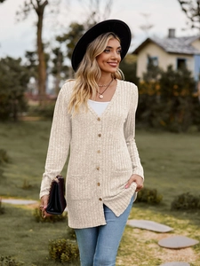 Detail of oatmeal ribbed knit cardigan with wooden buttons and front patch pockets