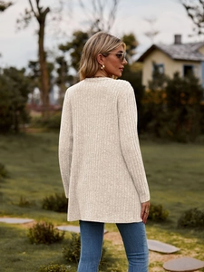 Detail of the textured beige ribbed knit fabric on a long sleeve open front cardigan