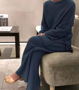 Détail de la texture en maille côtelée bleu marine du pull et du pantalon large