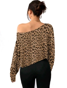 Detail of elegant leopard print off-shoulder long sleeve crop top with a stylish one-shoulder fit