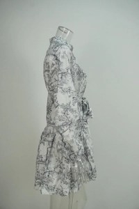 Side view of elegant Toile de Jouy floral midi dress with tie waist and tiered skirt
