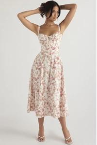 Close-up of pink rose floral midi dress with corset-style bodice and bow tie detail