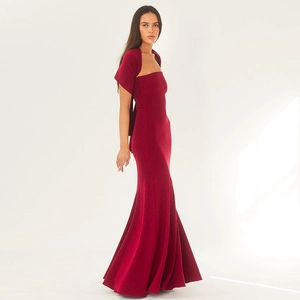 Close-up of deep red fishtail dress featuring pleated texture and matching shawl